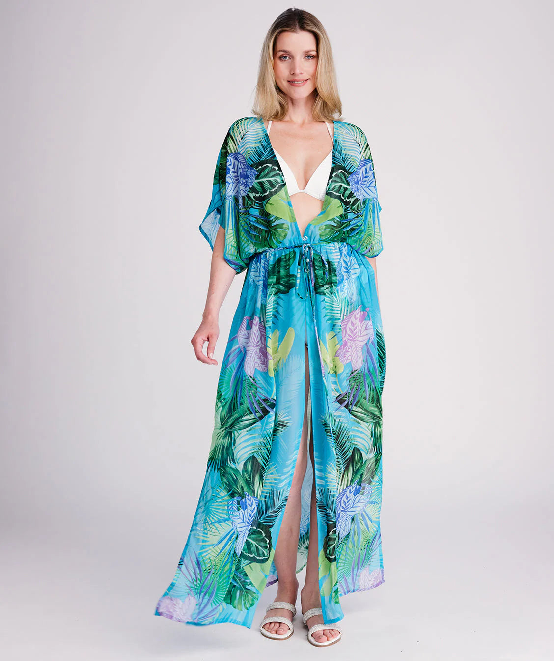Woman in a colorful dress standing on a wooden pier.